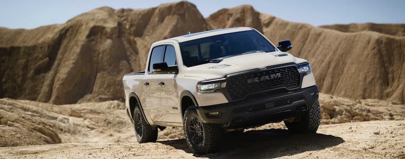 White 2026 Ram 1500 Rebel X driving off-road.