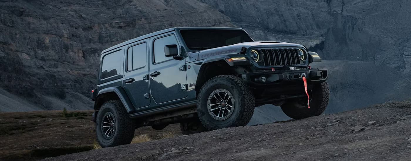 Grey 2026 Jeep Wrangler parked off-road on sand