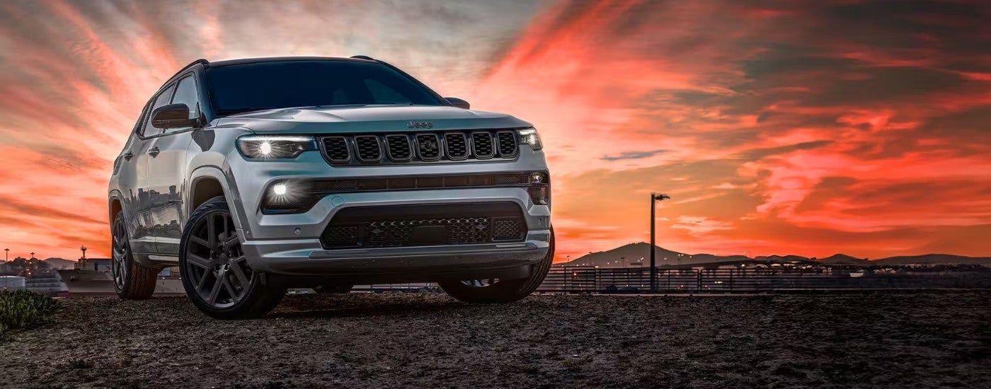 Grey 2025 Jeep Compass parked off-road.