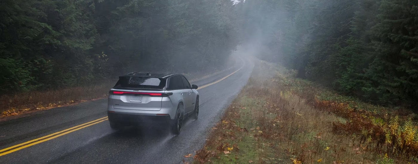 A silver 2024 Jeep Wagoneer S driving to a Jeep dealer.