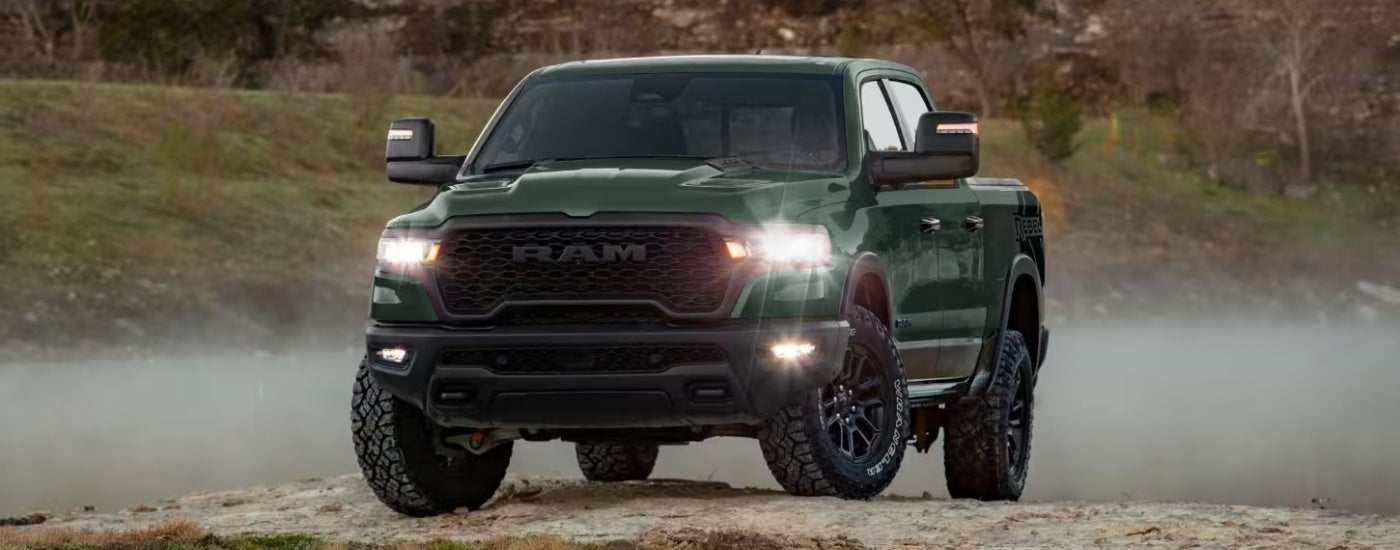A green 2026 Ram 1500 Rebel parked off-road.
