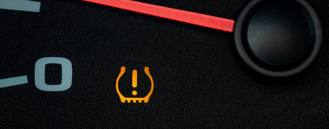 Tire pressure sensor light on a vehicle dashboard