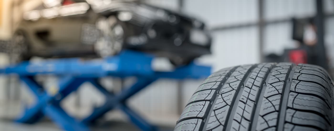 Vehicle on a lift for a tire rotation in a tire shop