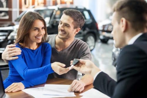 Dealer making a sell with two customers and providng a key
